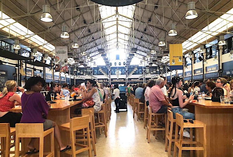 people seated at table in food hall